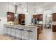 Bright kitchen featuring granite counters, stainless appliances, island with bar seating, and decorative lighting at 17347 Linda Vista Cir, Lutz, FL 33548