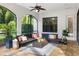 Screened lanai with comfortable seating, ceiling fan, and views of the backyard at 17347 Linda Vista Cir, Lutz, FL 33548