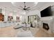 Open living room with fireplace, coffered ceilings, and sliding glass doors to the outside at 17347 Linda Vista Cir, Lutz, FL 33548