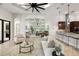 Spacious living room open to kitchen and sunroom with archways and tile flooring at 17347 Linda Vista Cir, Lutz, FL 33548
