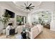 Bright open floor plan showcasing the living room with fireplace and access to lanai and sunroom at 17347 Linda Vista Cir, Lutz, FL 33548