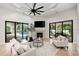 Comfortable living room with fireplace and sliding glass doors to the lanai and pool at 17347 Linda Vista Cir, Lutz, FL 33548