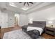 Comfortable main bedroom with wood floors, neutral walls, and a view to the bathroom at 17347 Linda Vista Cir, Lutz, FL 33548