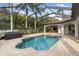Inviting pool area with spa, screened-in enclosure, and lush landscaping for a relaxing outdoor retreat at 17347 Linda Vista Cir, Lutz, FL 33548