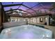 Relaxing enclosed pool area featuring a hot tub and tile patio with beautiful views at 17347 Linda Vista Cir, Lutz, FL 33548