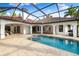 View of the outdoor pool and patio area with the arches and outdoor ceiling fans and elegant tile flooring at 17347 Linda Vista Cir, Lutz, FL 33548