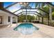 Bright and airy screened in lanai with a pool and spa and lush tropical plants and ample sunlight at 17347 Linda Vista Cir, Lutz, FL 33548