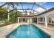 Relaxing pool and patio area with lush landscaping and screened enclosure for comfortable outdoor living at 17347 Linda Vista Cir, Lutz, FL 33548