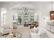 Inviting sunroom with coffered ceiling, large windows and tile flooring at 17347 Linda Vista Cir, Lutz, FL 33548