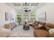 Cozy sunroom featuring a coffered ceiling, ample natural light, and comfortable seating at 17347 Linda Vista Cir, Lutz, FL 33548