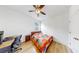 Small bedroom with a bed, desk, ceiling fan, and wood-look flooring at 17529 Buckingham Garden Dr, Lithia, FL 33547