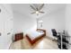Simple bedroom with a single bed, small desk, and a minimalist design at 17529 Buckingham Garden Dr, Lithia, FL 33547