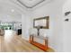 Bright foyer featuring high ceilings, neutral walls, light wood floors, and an elegant console table at 17529 Buckingham Garden Dr, Lithia, FL 33547