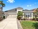 Charming single-Gathering home showcasing a well-manicured lawn and lovely landscaping at 17529 Buckingham Garden Dr, Lithia, FL 33547