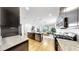 Open concept kitchen with modern appliances and finishes overlooks the dining and living areas at 17529 Buckingham Garden Dr, Lithia, FL 33547