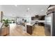 Open concept kitchen with a large island, stainless steel appliances, and a connected living area at 17529 Buckingham Garden Dr, Lithia, FL 33547