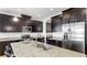 Modern kitchen with granite counters, stainless steel appliances, and a breakfast bar island at 17529 Buckingham Garden Dr, Lithia, FL 33547