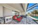 Relaxing screened patio featuring lounge chairs and a table, perfect for enjoying the outdoor space and the pool at 17529 Buckingham Garden Dr, Lithia, FL 33547