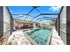 Gorgeous screened pool with a sun shelf, patio, and comfortable seating for outdoor relaxation and entertainment at 17529 Buckingham Garden Dr, Lithia, FL 33547