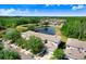 Elevated aerial perspective showcasing a home nestled amongst lush trees and a tranquil pond in the neighborhood at 19281 Stone Hedge Dr, Tampa, FL 33647