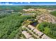 Breathtaking aerial view of a home surrounded by verdant trees, tranquil ponds and manicured landscapes at 19281 Stone Hedge Dr, Tampa, FL 33647