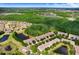 Stunning aerial view showcasing a home with lush landscapes, a serene lake, and vibrant trees at 19281 Stone Hedge Dr, Tampa, FL 33647