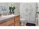 Well-lit bathroom with a white toilet and coordinated shower curtain in a modern residence at 19281 Stone Hedge Dr, Tampa, FL 33647