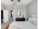 Spacious main bedroom features neutral colors, a ceiling fan, and a dresser with a mirror at 19281 Stone Hedge Dr, Tampa, FL 33647