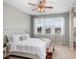 Serene main bedroom with a ceiling fan, natural light, and a view of the outdoors at 19281 Stone Hedge Dr, Tampa, FL 33647