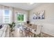 Bright dining room features a rustic wood table, bench seating, and sliding glass doors to the outdoor space at 19281 Stone Hedge Dr, Tampa, FL 33647