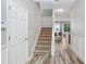Bright entryway with wood flooring leading to a living area and staircase to the upper level at 19281 Stone Hedge Dr, Tampa, FL 33647