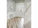 Home foyer featuring wood floors, white wainscoting, and a staircase leading to the upper level at 19281 Stone Hedge Dr, Tampa, FL 33647