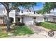 Inviting townhome with well-manicured lawn, stone accents, and a two-car garage at 19281 Stone Hedge Dr, Tampa, FL 33647