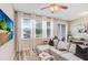 Sunlit living space featuring a sectional sofa, large windows, and a dining table at 19281 Stone Hedge Dr, Tampa, FL 33647