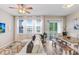 Cozy living room featuring a comfortable sofa, large windows, and adjacent dining area at 19281 Stone Hedge Dr, Tampa, FL 33647