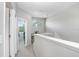 Bright upstairs hallway leads to bedrooms, featuring plush carpeting and neutral paint colors at 19281 Stone Hedge Dr, Tampa, FL 33647