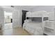 Comfortable bedroom featuring bunk beds and a convenient connection to the kitchen, ideal for a Gathering at 1935 Gulf Of Mexico Dr # G7-304, Longboat Key, FL 34228