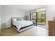 Bright main bedroom with a private balcony overlooking lush greenery, creating a serene retreat at 1935 Gulf Of Mexico Dr # G7-304, Longboat Key, FL 34228