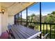 Relax on this screened patio with a ceiling fan, table, and chairs, offering views of the lush outdoor greenery at 1935 Gulf Of Mexico Dr # G7-304, Longboat Key, FL 34228