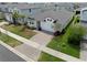 Aerial view of a well-maintained home featuring manicured landscaping and a two-car garage in a residential neighborhood at 2477 Water Willow Dr, Lutz, FL 33558