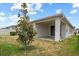 Covered back patio leads to the fenced yard at 2477 Water Willow Dr, Lutz, FL 33558