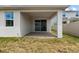 An outdoor covered patio with a brick floor and sliding glass doors provides a seamless transition to outdoor living at 2477 Water Willow Dr, Lutz, FL 33558