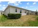 Spacious backyard with lush green grass and privacy landscaping offers a serene outdoor retreat at 2477 Water Willow Dr, Lutz, FL 33558
