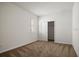 Bright bedroom with a window featuring white shutters and neutral-colored carpet flooring at 2477 Water Willow Dr, Lutz, FL 33558