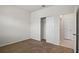 Neutral carpeted bedroom with closet featuring bi-fold doors and access to en-suite bathroom at 2477 Water Willow Dr, Lutz, FL 33558