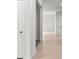 Bright hallway featuring neutral tile flooring, fresh paint, and access to multiple rooms at 2477 Water Willow Dr, Lutz, FL 33558