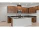 Open kitchen with stainless steel appliances, dark countertops, wood cabinets and tile flooring at 2477 Water Willow Dr, Lutz, FL 33558