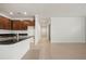 Open-concept kitchen with stainless steel appliances, granite countertop island, and tile flooring at 2477 Water Willow Dr, Lutz, FL 33558