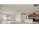 Bright living room with tile flooring, sliding glass doors to backyard, and open-concept design at 2477 Water Willow Dr, Lutz, FL 33558
