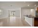 Inviting living area featuring tile floors, a breakfast bar, and seamless flow into the kitchen at 2477 Water Willow Dr, Lutz, FL 33558